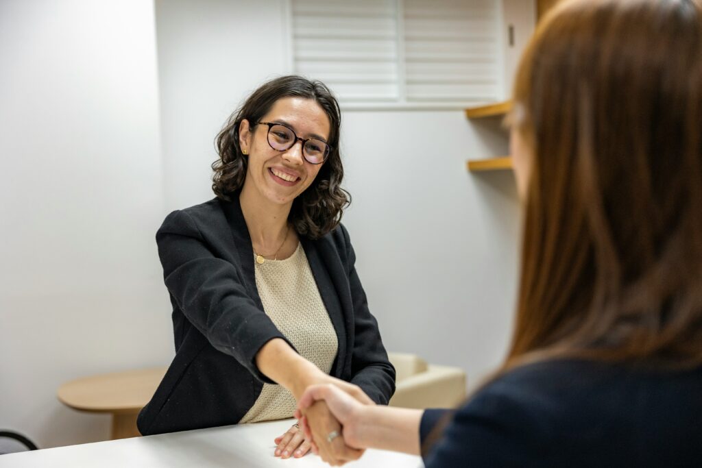 Indian Freelancing graphic designer shaking hands after deal is finalized